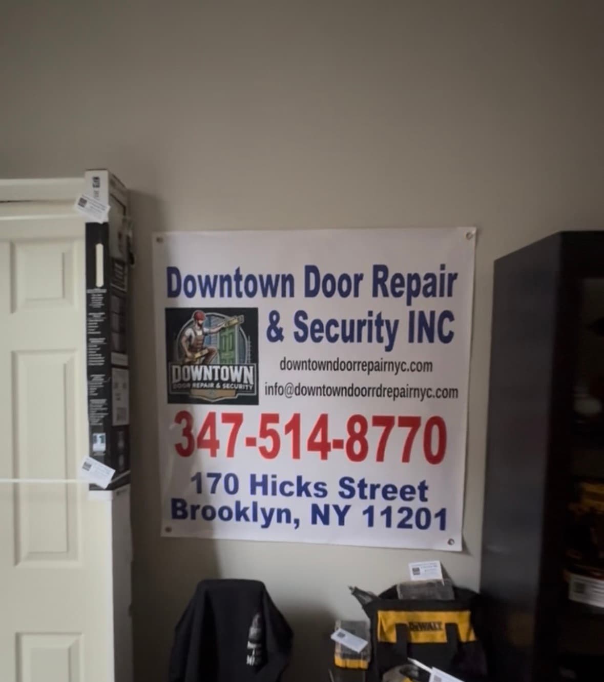Inside the Brooklyn Heights office — company banner with NAP over the tool and hardware staging area