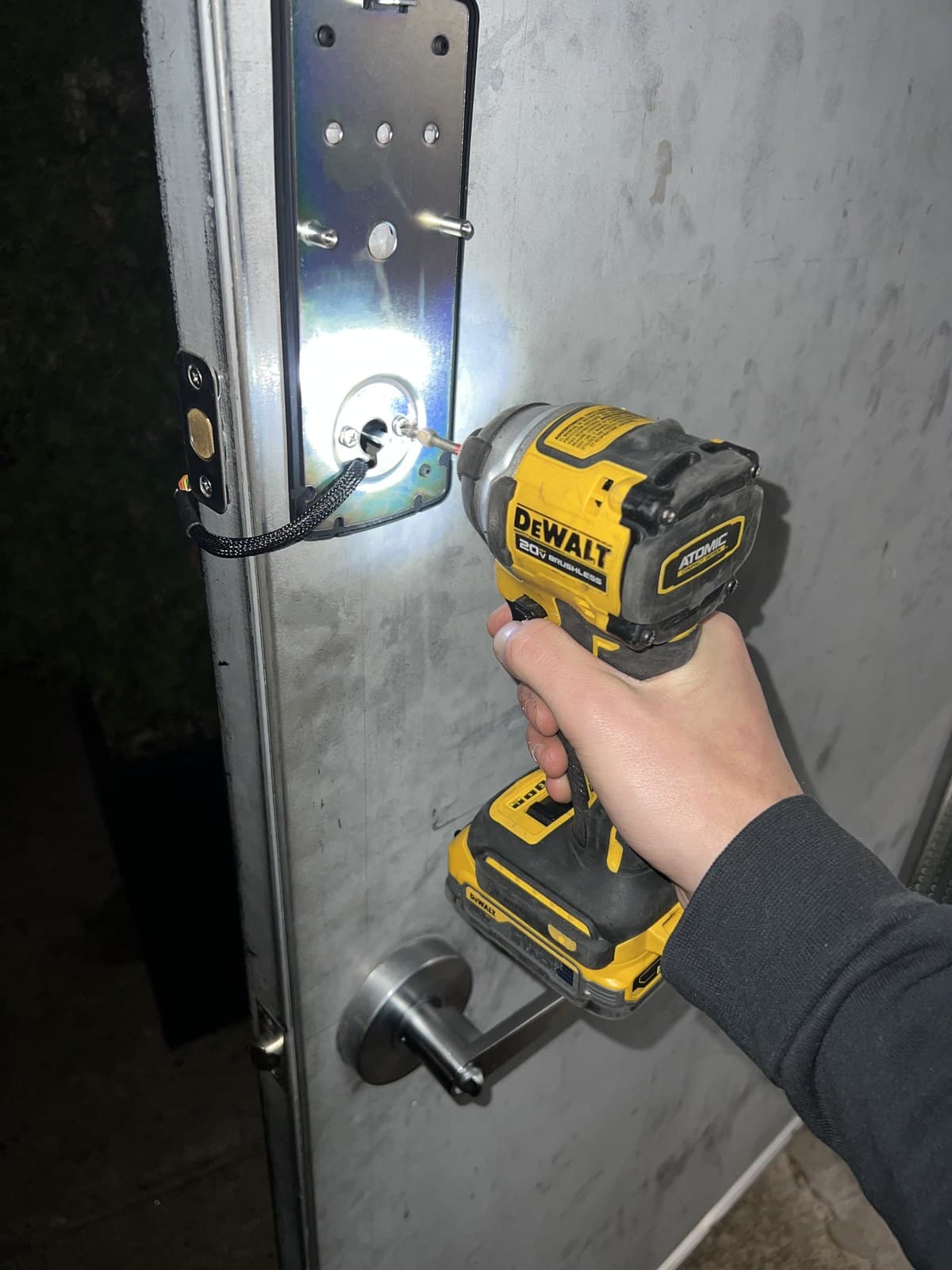 Electric strike being fitted into a commercial frame