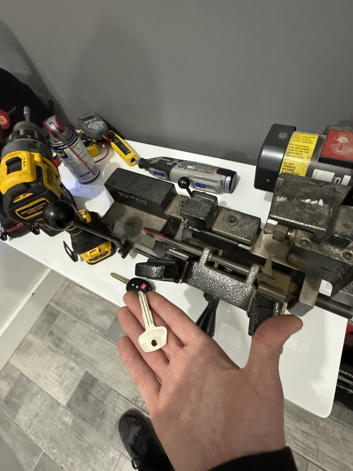 Cutting a car key on the bench