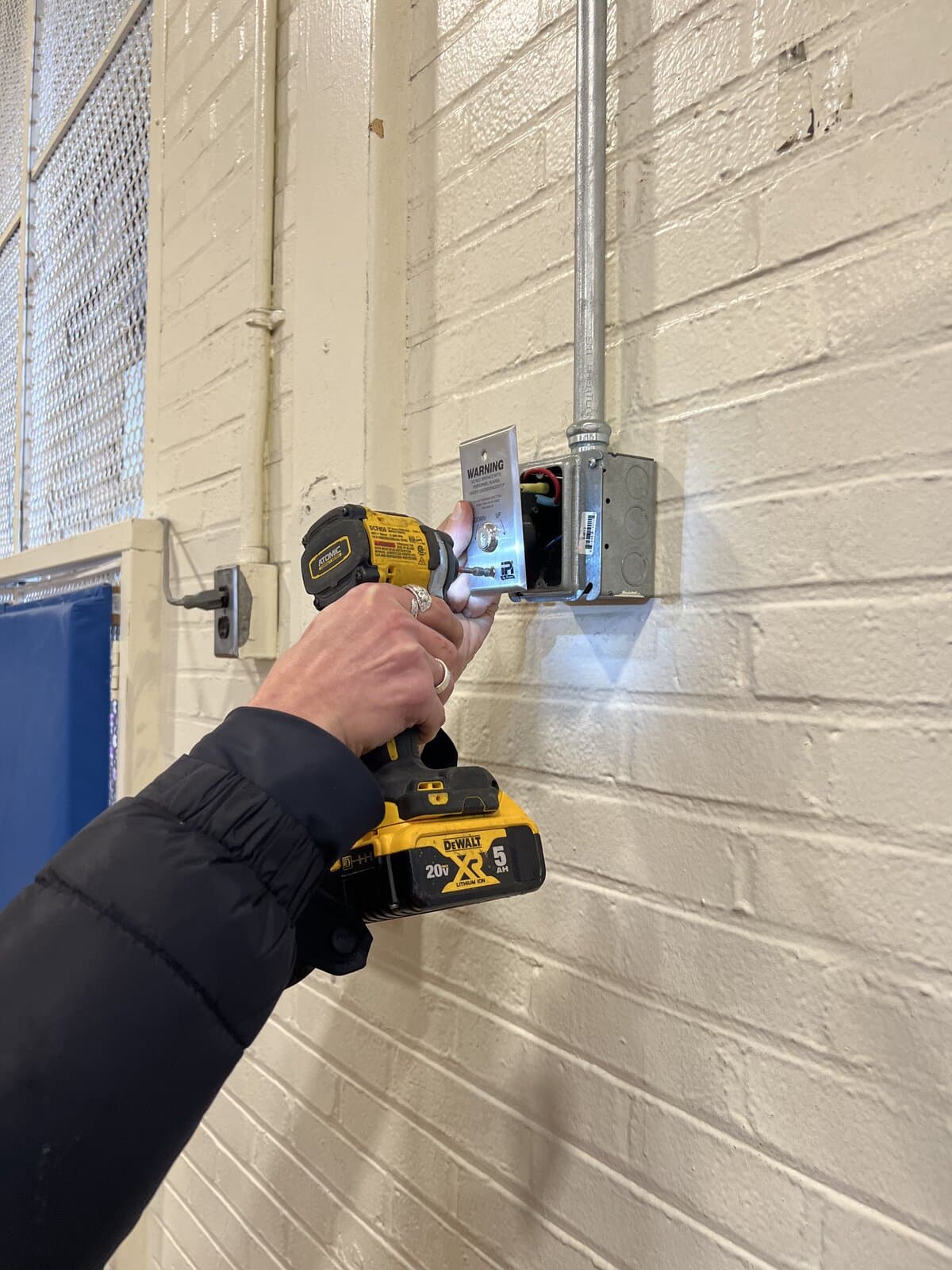 Drilling the frame to cut in a strike plate on a commercial door