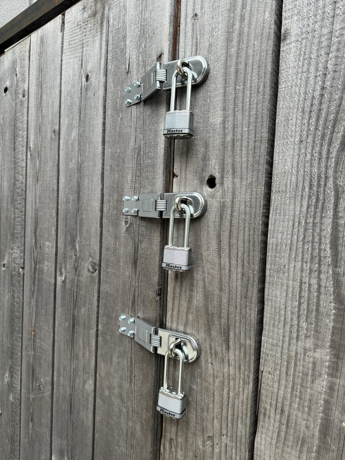 Hasp and padlock hardware on a gate install